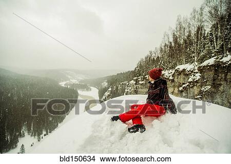 Caucasian hiker sitting on snowy hilltop View Large Photo Image Picture - Caucasian hiker sitting on snowy hilltop. Fotosearch