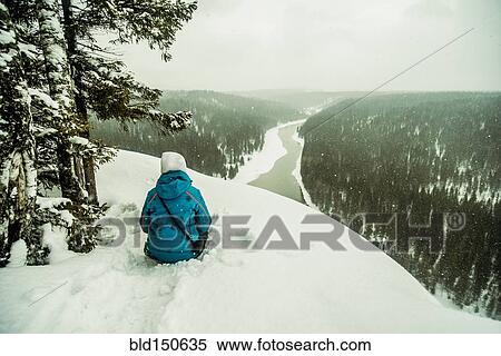 Caucasian hiker sitting on snowy hilltop View Large Photo Image Stock Photography - Caucasian hiker sitting on snowy hilltop. Fotosearch