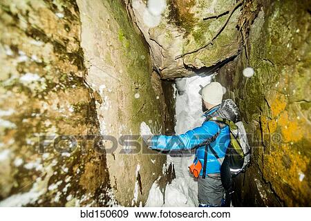 Caucasian hiker standing in snowy cave View Large Photo Image Stock Photo - Caucasian hiker standing in snowy cave. Fotosearch