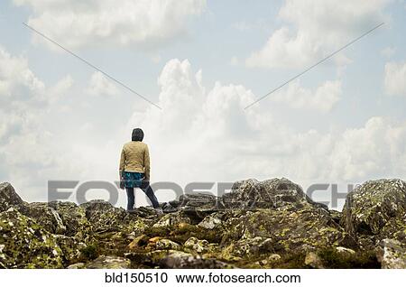 Caucasian hiker standing on rocky hilltop View Large Photo Image Stock Image - Caucasian hiker standing on rocky hilltop. Fotosearch