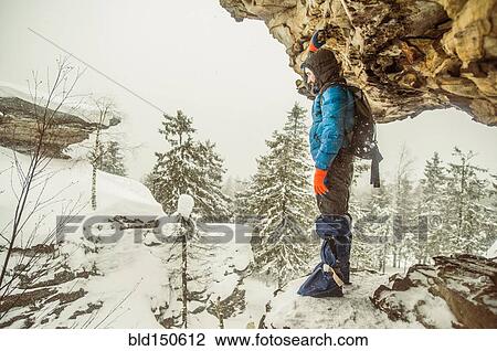 Caucasian hiker standing on snowy rock formations View Large Photo Image Stock Image - Caucasian hiker standing on snowy rock formations. Fotosearch