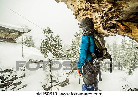 Caucasian hiker standing on snowy rock formations View Large Photo Image Stock Image - Caucasian hiker standing on snowy rock formations. Fotosearch