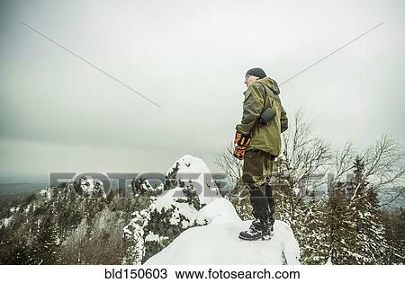 Caucasian hiker standing on snowy hilltop View Large Photo Image Stock Image - Caucasian hiker standing on snowy hilltop. Fotosearch