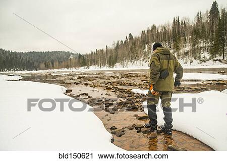 Caucasian hiker walking in rocky remote river View Large Photo Image Stock Image - Caucasian hiker walking in rocky remote river. Fotosearch