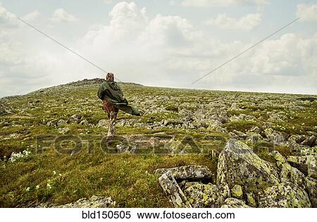 Caucasian hiker walking on rocky hillside View Large Photo Image Stock Photography - Caucasian hiker walking on rocky hillside. Fotosearch