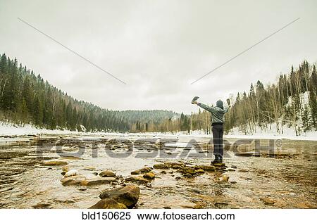 Caucasian hiker with arms outstretched standing in remote river View Large Photo Image Stock Photography - Caucasian hiker with arms outstretched standing in remote river. Fotosearch