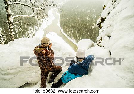 Caucasian hikers enjoying view from snowy hilltop View Large Photo Image Stock Image - Caucasian hikers enjoying view from snowy hilltop. Fotosearch