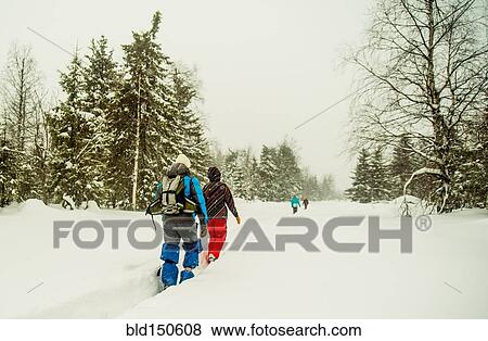 Caucasian hikers walking in deep snow View Large Photo Image Stock Photo - Caucasian hikers walking in deep snow. Fotosearch
