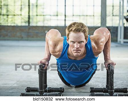 Caucasian man doing push ups in warehouse gym View Large Photo Image Stock Image - Caucasian man doing push ups in warehouse gym. Fotosearch