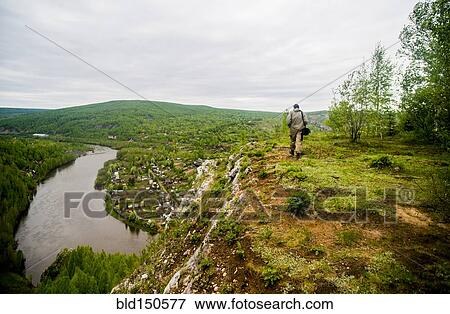 Caucasian man hiking in remote landscape View Large Photo Image Stock Photo - Caucasian man hiking in remote landscape. Fotosearch