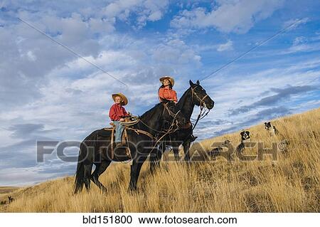 Caucasian mother and son on horseback on grassy hill View Large Photo Image Stock Image - Caucasian mother and son on horseback on grassy hill. Fotosearch