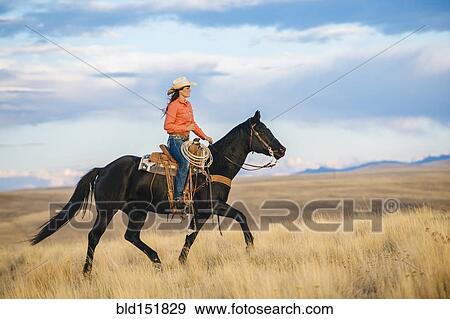 Caucasian mother and son riding horses in grassy field View Large Photo Image Stock Photo - Caucasian mother and son riding horses in grassy field. Fotosearch