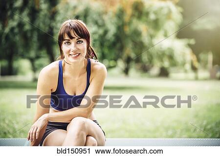 Caucasian runner sitting in park View Large Photo Image Stock Image - Caucasian runner sitting in park. Fotosearch
