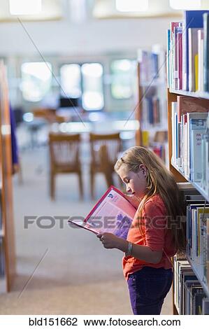 Caucasian student reading book in library View Large Photo Image Stock Image - Caucasian student reading book in library. Fotosearch