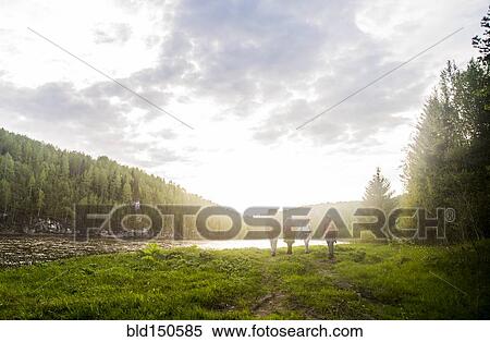 Caucasian tourists walking near river in remote landscape View Large Photo Image Stock Photography - Caucasian tourists walking near river in remote landscape. Fotosearch