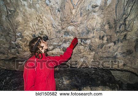 Caucasian woman admiring rock formations in cave View Large Photo Image Stock Image - Caucasian woman admiring rock formations in cave. Fotosearch