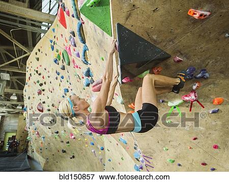 Caucasian woman climbing indoor rock wall View Large Photo Image Stock Photo - Caucasian woman climbing indoor rock wall. Fotosearch