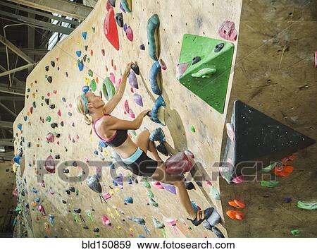 Caucasian woman climbing indoor rock wall View Large Photo Image Stock Photo - Caucasian woman climbing indoor rock wall. Fotosearch