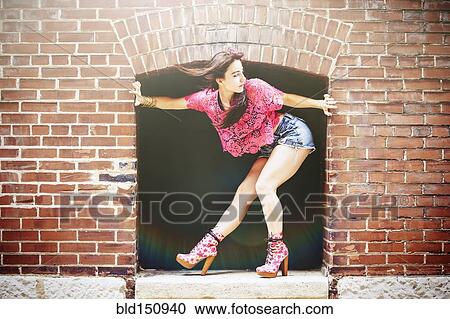 Caucasian woman crouching in alcove on sidewalk View Large Photo Image Stock Image - Caucasian woman crouching in alcove on sidewalk. Fotosearch