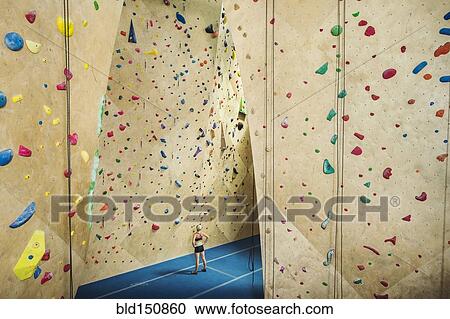 Caucasian woman examining indoor rock wall View Large Photo Image Stock Image - Caucasian woman examining indoor rock wall. Fotosearch