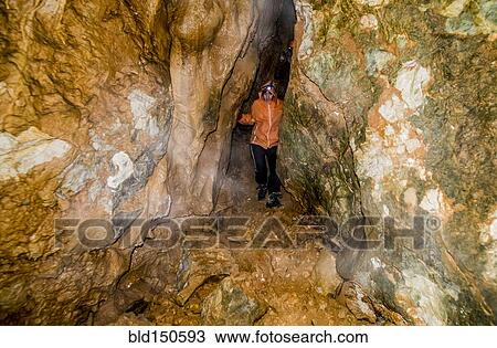 Caucasian woman exploring rock formation cave View Large Photo Image Stock Image - Caucasian woman exploring rock formation cave. Fotosearch