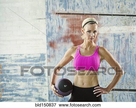 Caucasian woman holding medicine ball View Large Photo Image Stock Photo - Caucasian woman holding medicine ball. Fotosearch