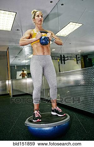 Caucasian woman lifting weights in gym View Large Photo Image Stock Photo - Caucasian woman lifting weights in gym. Fotosearch