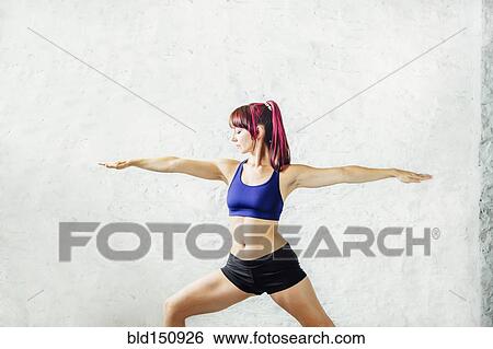 Stock Photograph - Caucasian woman practicing yoga. Fotosearch