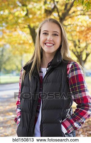 Caucasian woman smiling in park View Large Photo Image Stock Image - Caucasian woman smiling in park. Fotosearch