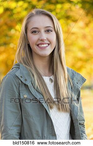 Caucasian woman smiling in park View Large Photo Image Stock Photograph - Caucasian woman smiling in park. Fotosearch