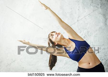 Caucasian woman stretching View Large Photo Image Stock Photography - Caucasian woman stretching. Fotosearch