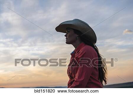 Caucasian woman under sunset sky View Large Photo Image Stock Image - Caucasian woman under sunset sky. Fotosearch