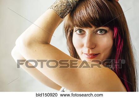 Stock Image - Caucasian woman with dyed hair smiling. Fotosearch