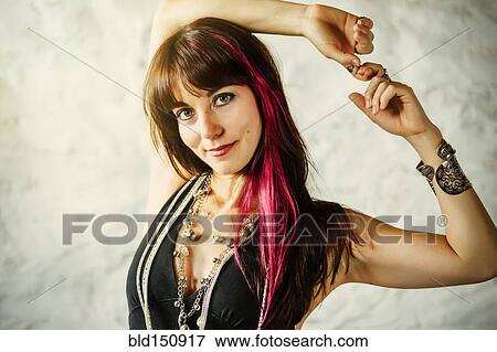 Stock Photo - Caucasian woman with dyed hair smiling. Fotosearch