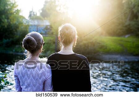 Caucasian women admiring river View Large Photo Image Stock Photo - Caucasian women admiring river. Fotosearch