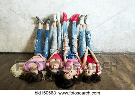 Caucasian women laying on floor with feet on wall View Large Photo Image Stock Image - Caucasian women laying on floor with feet on wall. Fotosearch