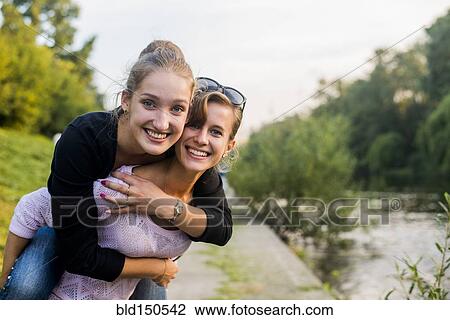 Caucasian women playing near river View Large Photo Image Stock Image - Caucasian women playing near river. Fotosearch