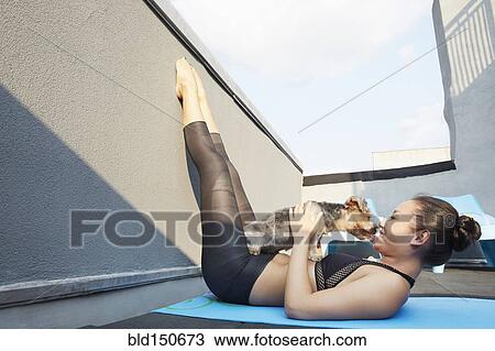 Chinese woman practicing yoga with dog on deck View Large Photo Image Stock Image - Chinese woman practicing yoga with dog on deck. Fotosearch