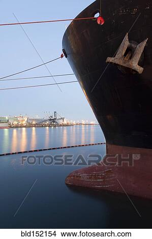 Picture - Close up of bow of ship docked in industrial harbor. Fotosearch