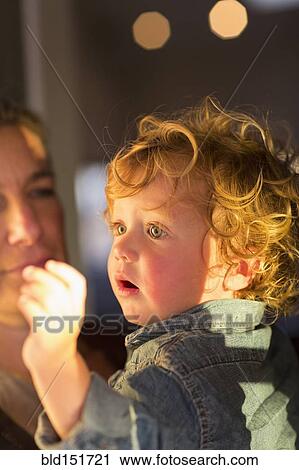 Close up of Caucasian mother holding baby View Large Photo Image Stock Image - Close up of Caucasian mother holding baby. Fotosearch