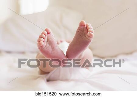 Stock Image - Close up of feet of mixed race baby. Fotosearch