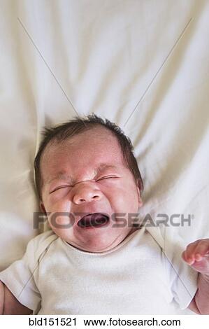 Close up of mixed race baby crying on bed View Large Photo Image Stock Image - Close up of mixed race baby crying on bed. Fotosearch