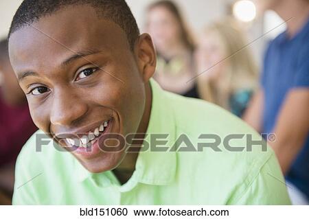 Stock Image - Close up of smiling face of teenage boy. Fotosearch