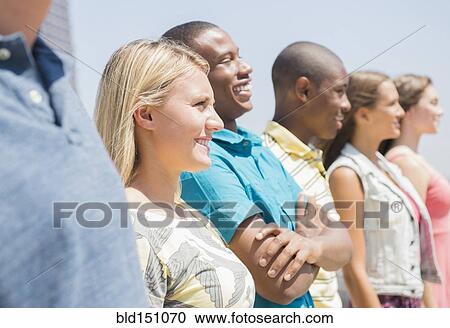 Close up of teenagers standing in a row outdoors View Large Photo Image Stock Image - Close up of teenagers standing in a row outdoors. Fotosearch