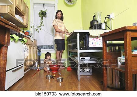 Father and daughter playing in kitchen View Large Photo Image Stock Image - Father and daughter playing in kitchen. Fotosearch