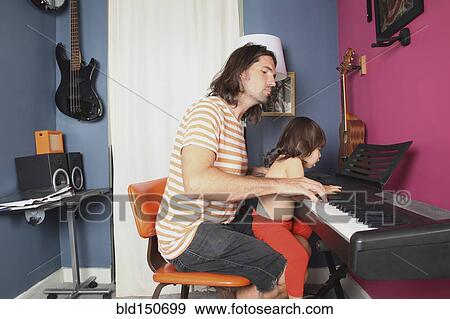 Father and daughter playing piano View Large Photo Image Stock Photo - Father and daughter playing piano. Fotosearch