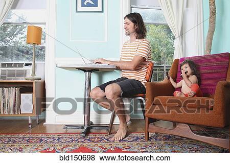 Stock Photo - Father and daughter relaxing in living room. Fotosearch