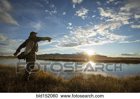 Fisherman casting in river View Large Photo Image Stock Image - Fisherman casting in river. Fotosearch