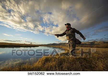 Fisherman casting in river View Large Photo Image Stock Image - Fisherman casting in river. Fotosearch