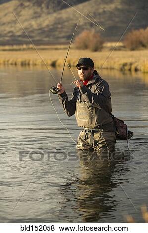 Stock Photo - Fisherman casting in river. Fotosearch